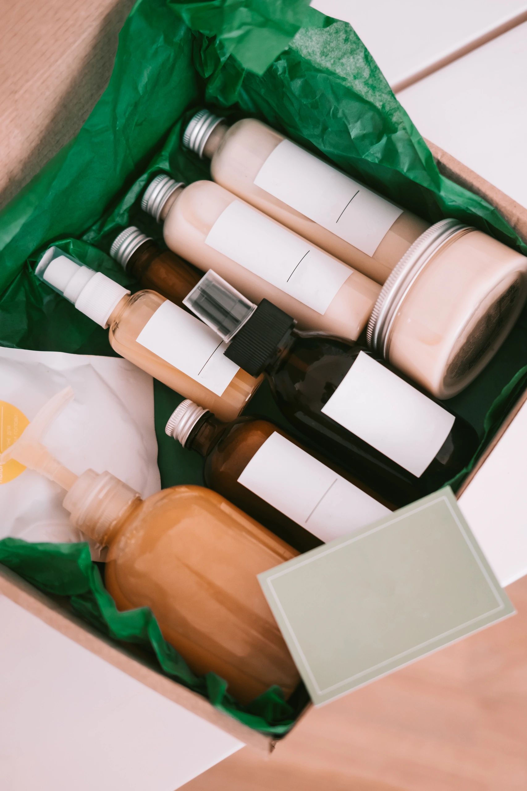 Natural skincare bottles styled with botanical greenery