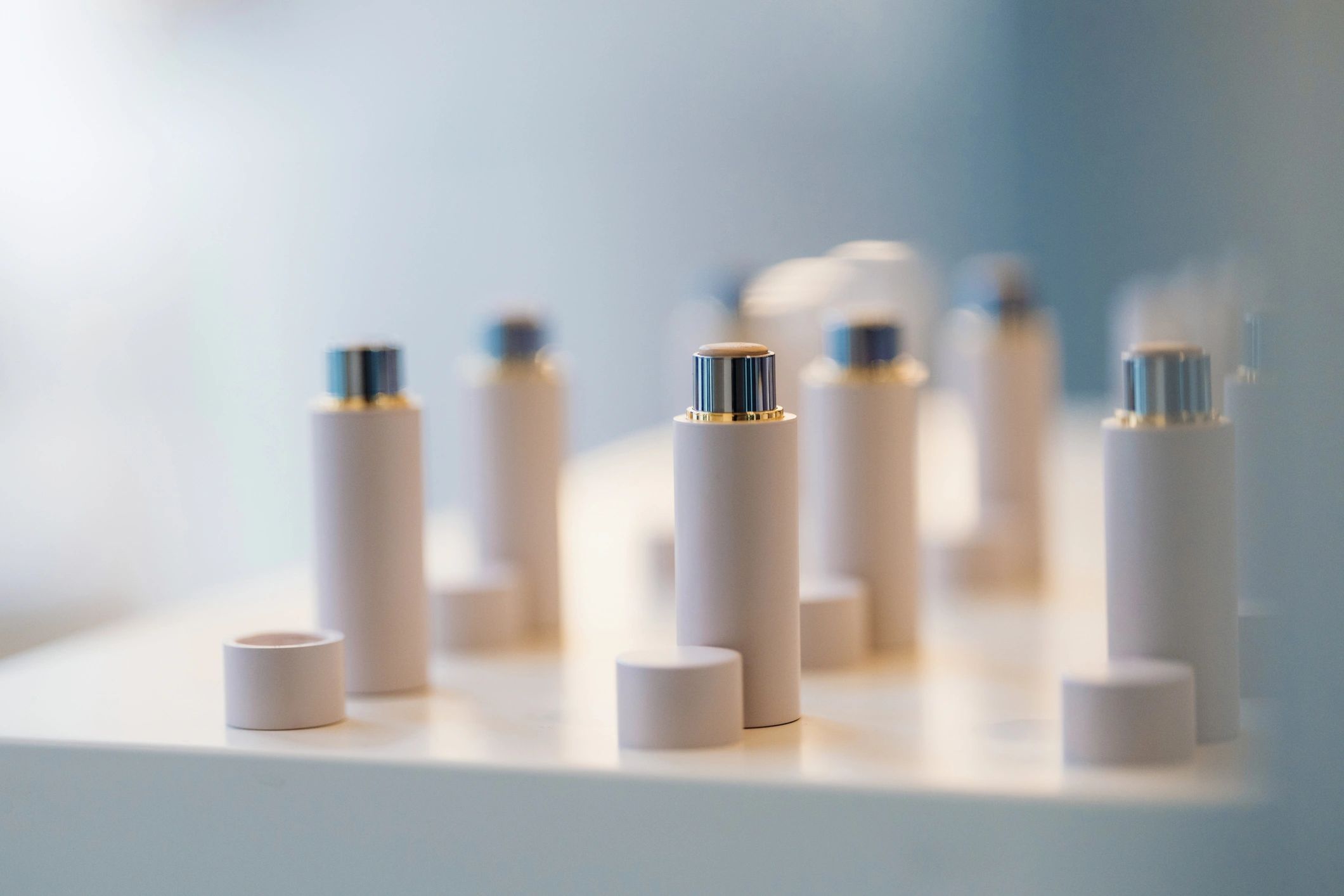 Minimal skincare bottles in soft luxury lighting