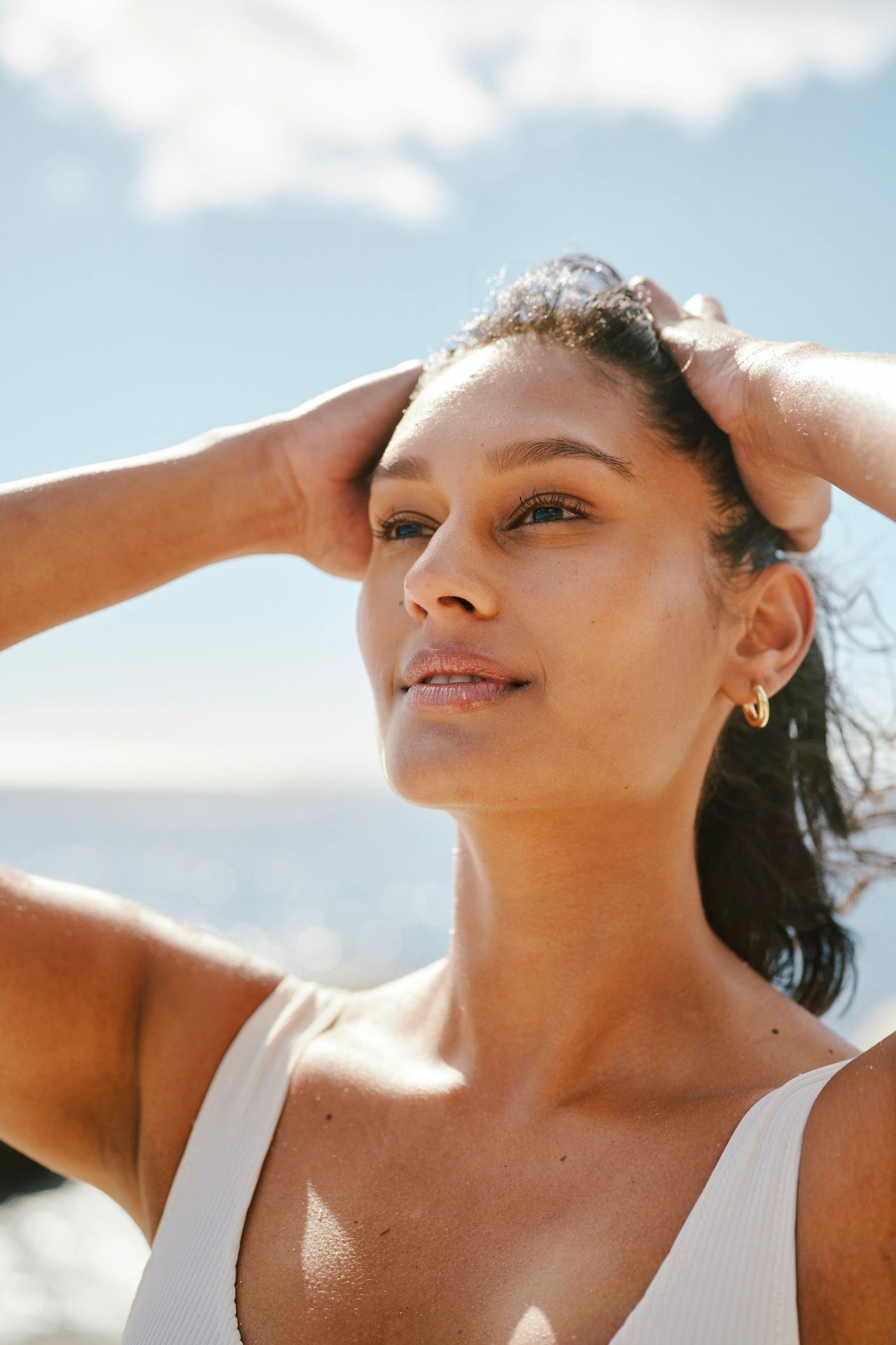 Woman enjoying a radiant skincare moment in sunlight